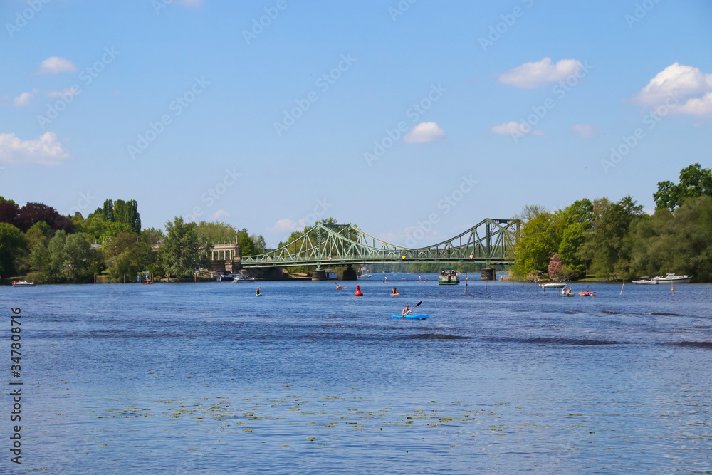 Obraz premium Beautiful view to the famous Glienicke Bridge (Glienicker Bruecke) across the havel river who connecting Berlin with Brandenburg, Germany