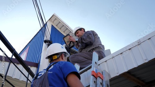 Technician makes repairs in the technical box of the Internet provider