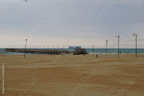 The black sea during a spring storm. The waves are rising high. Clouds hang low over the water. The deserted beach makes a grim impression.