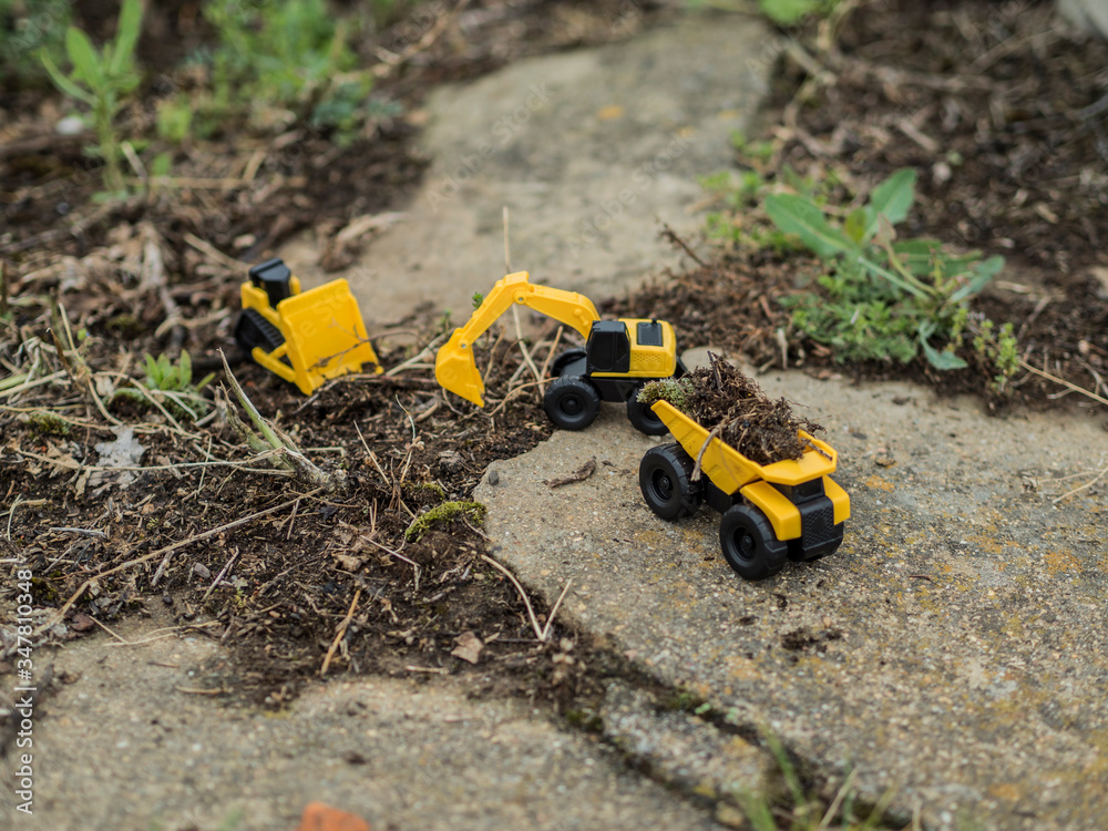 Toy construction machinery working on an excavation Toy construction machinery working on an excavation