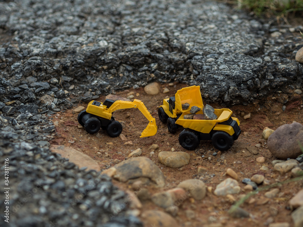 Toy construction machinery working on an excavation Toy construction machinery working on an excavation