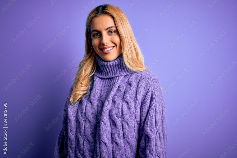 Young beautiful blonde woman wearing casual turtleneck sweater over purple background with a happy and cool smile on face. Lucky person. Young beautiful blonde woman wearing casual turtleneck sweater over purple background with a happy and cool smile on face. Lucky person.