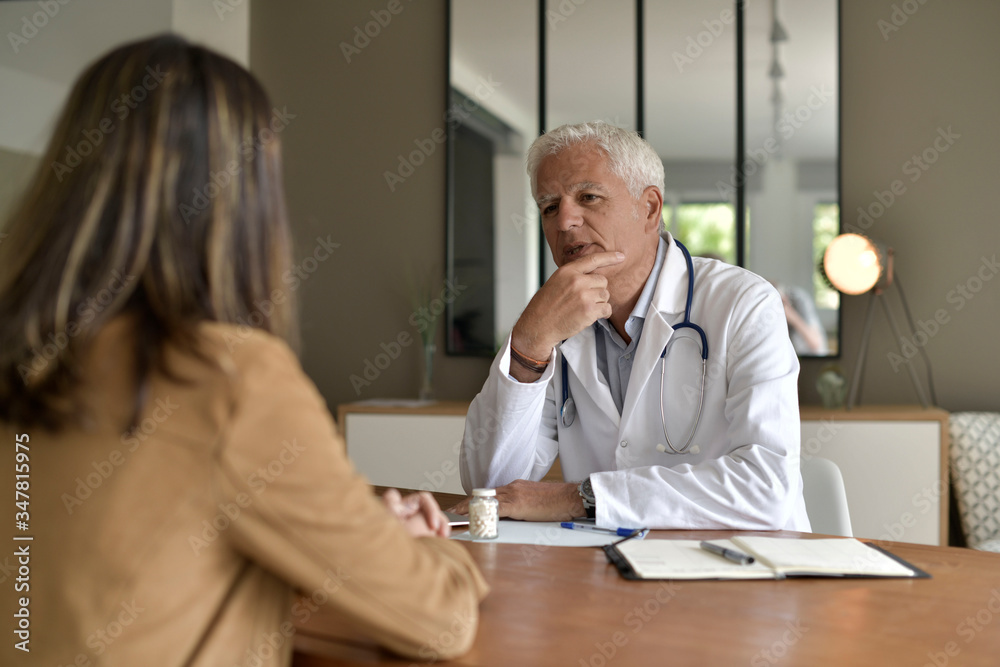 Doctor attending patient in office Doctor attending patient in office