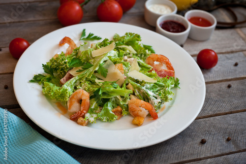 salad caesar with shrimps on white plate