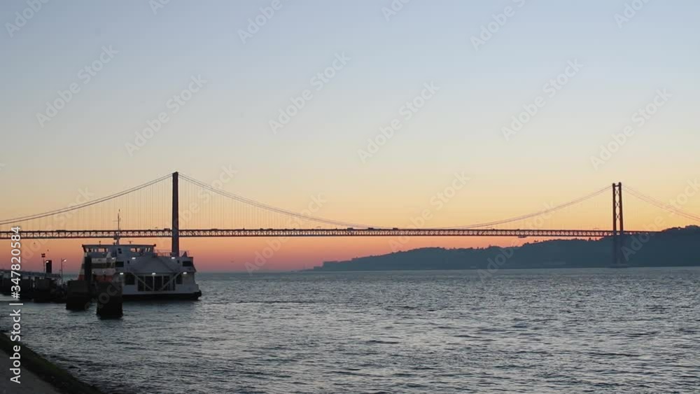The sun rises above the river bridge with the ship on the dock The sun rises above the river bridge with the ship on the dock