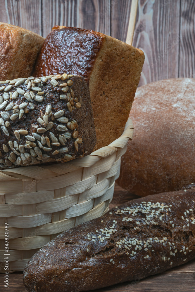fresh loaves of wheat bread of different grades and sizes in a straw