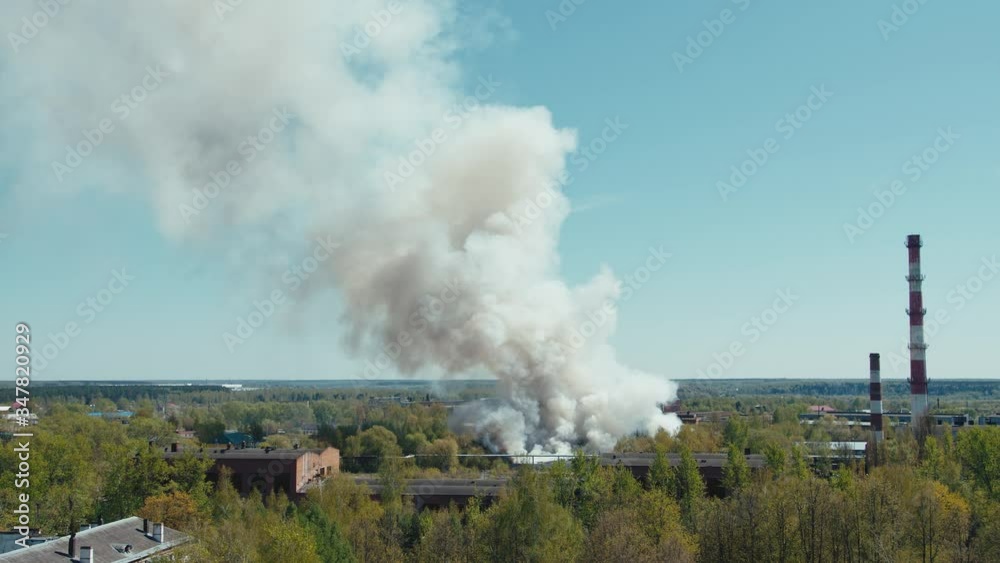 A big fire burns a factory or warehouse a powerful fire and a lot of smoke A big fire burns a factory or warehouse a powerful fire and a lot of smoke