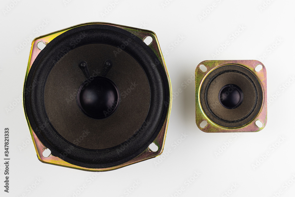Large and small loudspeakers on a white background. Large and small loudspeakers on a white background.