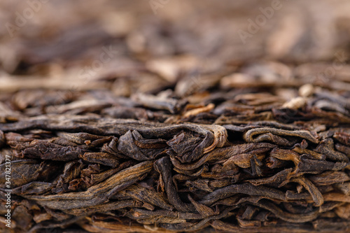 Chinese pressed puer tea on wrapping paper, close-up, macro