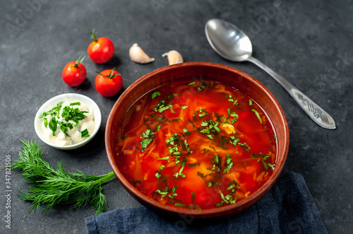 Borscht - Traditional Ukrainian dish in a plate on a stone background
