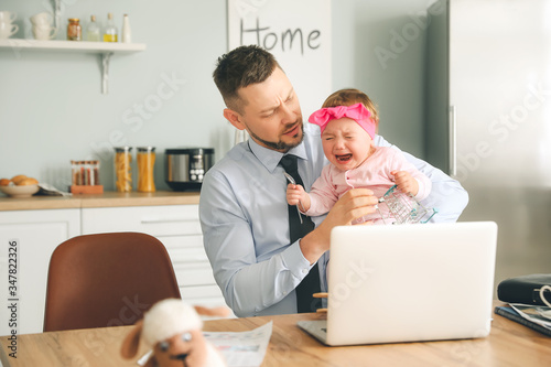 Working father with crying ...