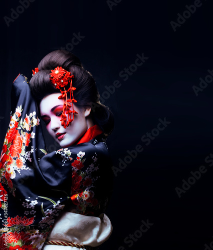 Canvas-taulu young pretty geisha in kimono with sakura and decoration