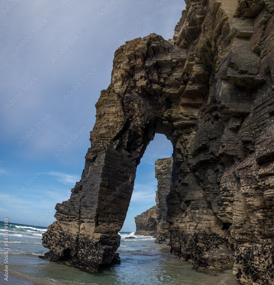 natural arches elephant shaped rock formation at praia de aguas santas beach