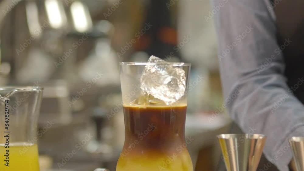 woman adding ice cube in to te glass - static woman adding ice cube in to te glass - static