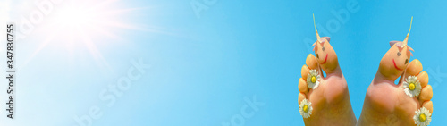 Hello summer background banner panorama - bare children's feet with flowers and smileys isolated on blue sky with sunshine and copy space