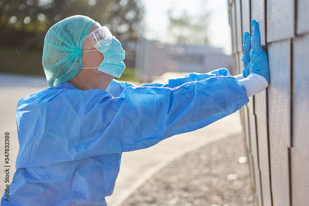 Doctor in protective clothing during coronavirus pandemic is overworked