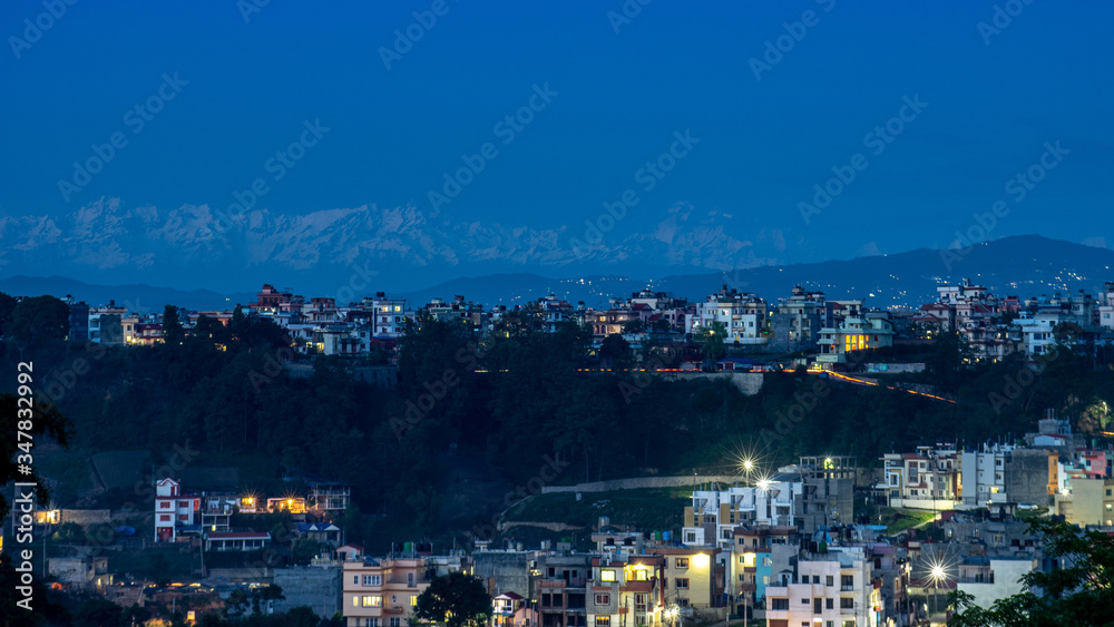 Lights in the City with the Himalaya Mountains in the Background