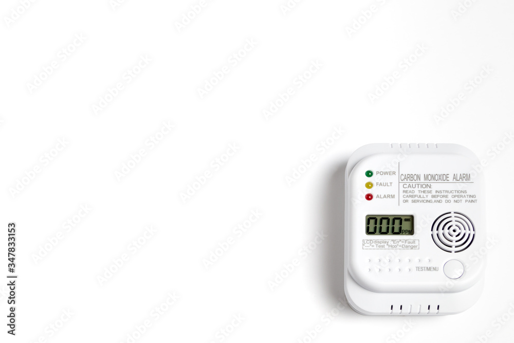 Carbon monoxide detector on a white wall. Stay home safe. Home control and security. CO detector Carbon monoxide detector on a white wall. Stay home safe. Home control and security. CO detector