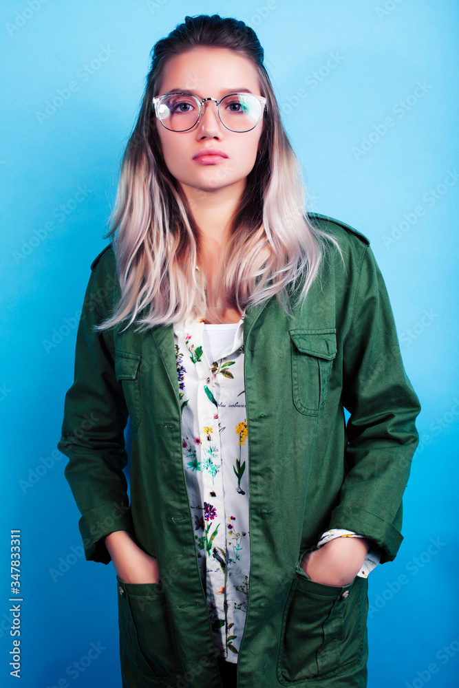 young pretty girl posing happy smiling on blue background, lifestyle people on summer vacation concept young pretty girl posing happy smiling on blue background, lifestyle people on summer vacation concept