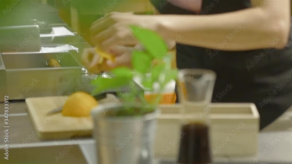 Woman picking up a slice of orange and put on cup Woman picking up a slice of orange and put on cup