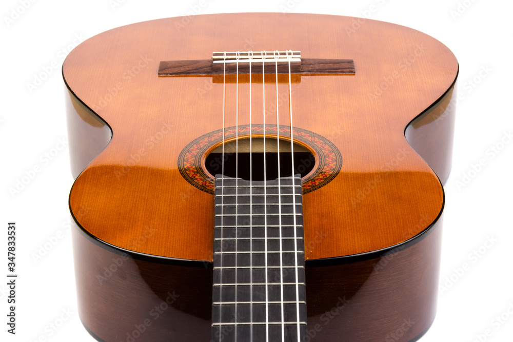 Obraz premium Acoustic guitar neck with body and strings on white background in close-up