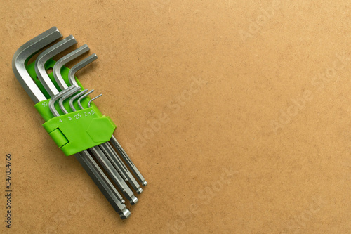 
Set of hex wrenches on plywood background. Copy space.