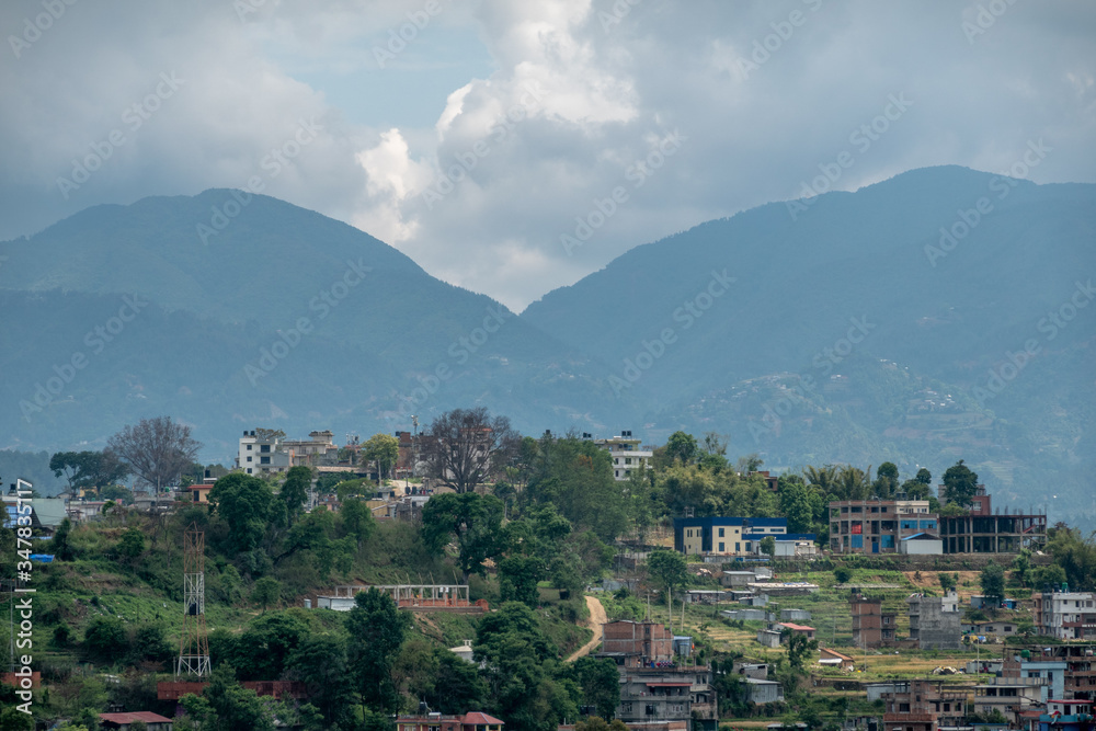 Village on a Hilltop Surrounded by Mountains