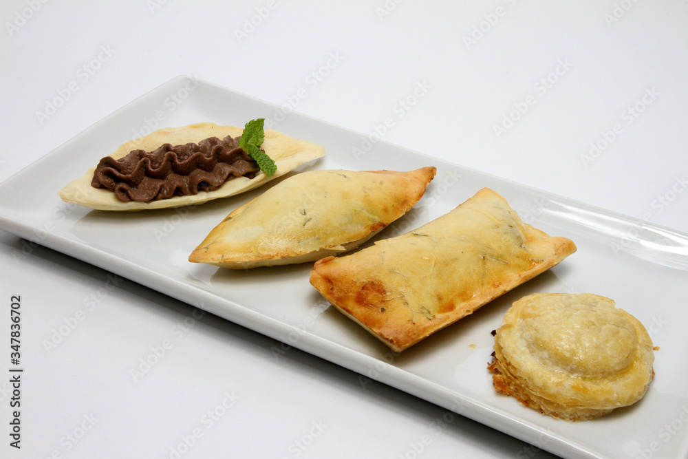 Four different types of rustico, traditional pastry from Lecce, Italy. Finger food