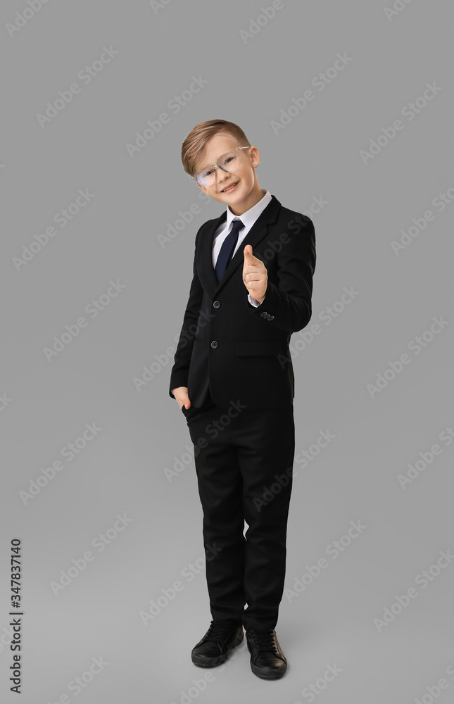 Portrait of little secretary pointing at viewer on grey background Portrait of little secretary pointing at viewer on grey background