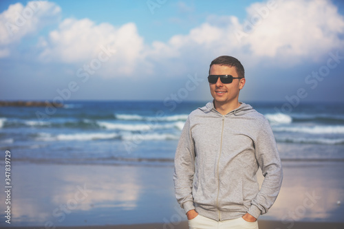 Man walking on the beach. Person going on seaside on a sunny day