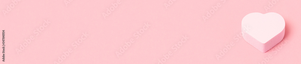 Pink heart makeup sponge or beauty blender on pink background, beauty and romance concept