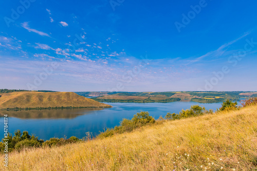 picturesque summer landscape nature scenic view of high hills beautiful lake shore line area August month season time photography concept © Артём Князь