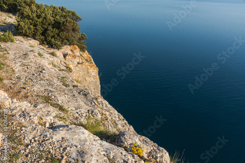 View of the sea from the top of the cliff. Beautiful landscape with mountain and blue sea background. Panorama of the sea landscape without people. A tourist destination.