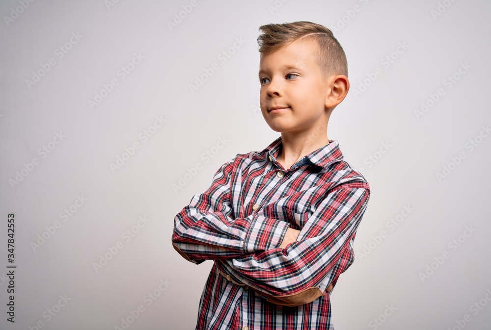 Young little caucasian kid with blue eyes wearing elegant shirt standing over isolated background looking to the side with arms crossed convinced and confident Young little caucasian kid with blue eyes wearing elegant shirt standing over isolated background looking to the side with arms crossed convinced and confident