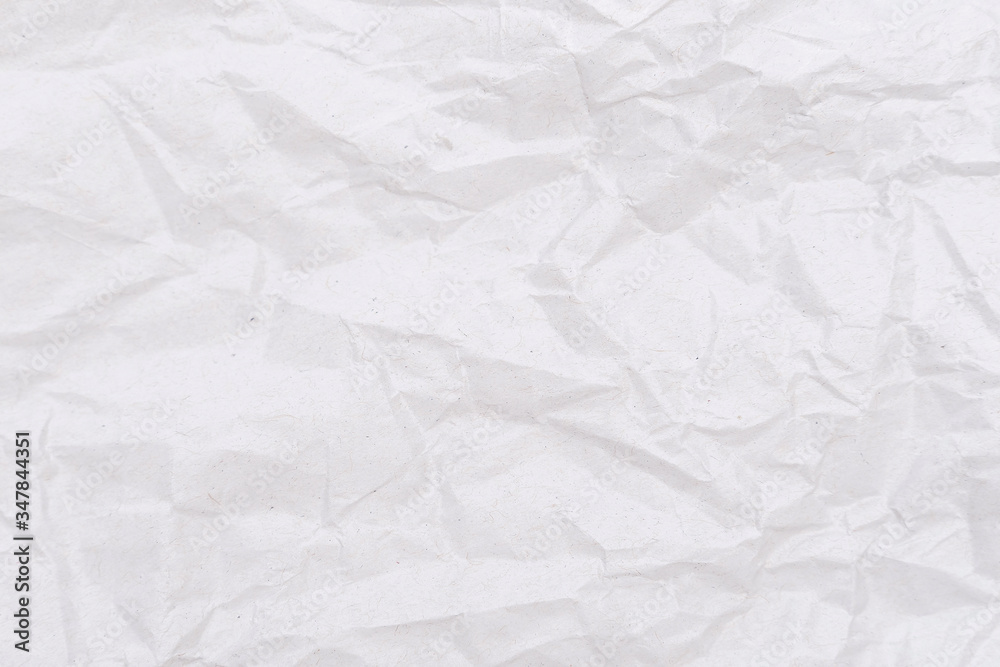 Obraz premium White crumpled paper texture. Abstract paper pattern for background. Close-up.