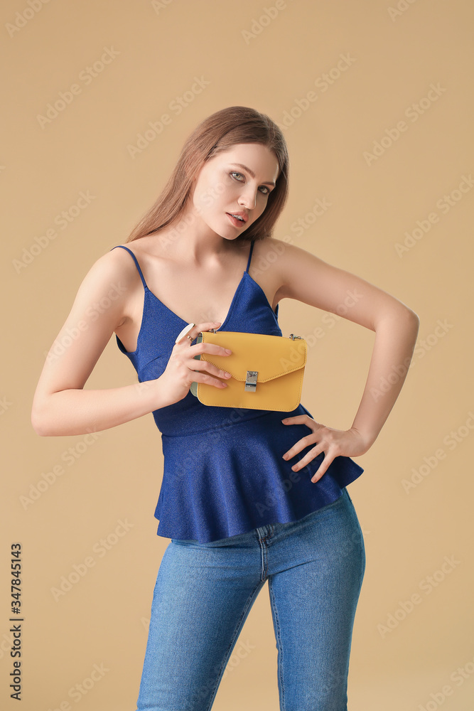 Beautiful woman with stylish bag on color background Beautiful woman with stylish bag on color background