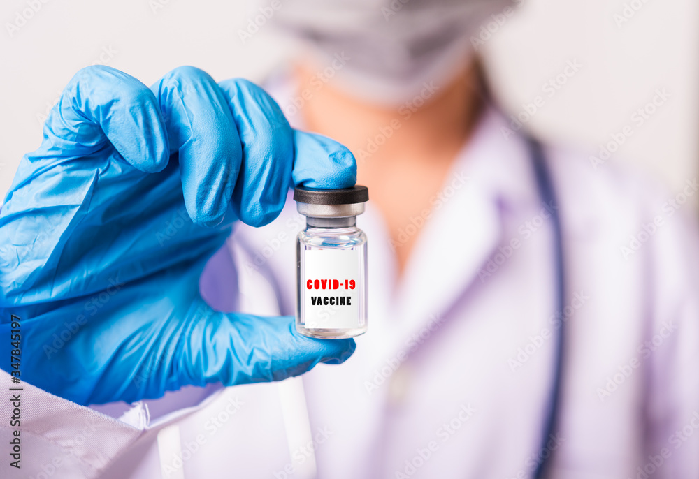 Asian female woman doctor or nurse in uniform and gloves wearing face mask protective in laboratory holding vial corona vaccine bottle on hand and bottle have Asian female woman doctor or nurse in uniform and gloves wearing face mask protective in laboratory holding vial corona vaccine bottle on hand and bottle have