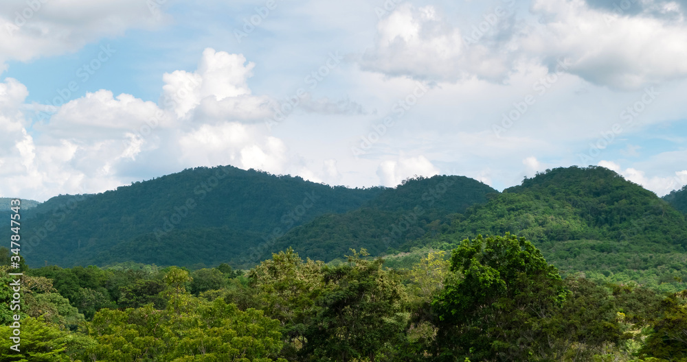 Green mountains and beautiful sky clouds under blue sky. Outdoor landscape natural background.