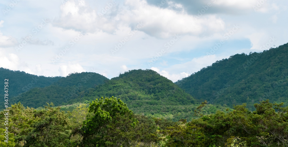 Green mountains and beautiful sky clouds under blue sky. Outdoor landscape natural background. Green mountains and beautiful sky clouds under blue sky. Outdoor landscape natural background.