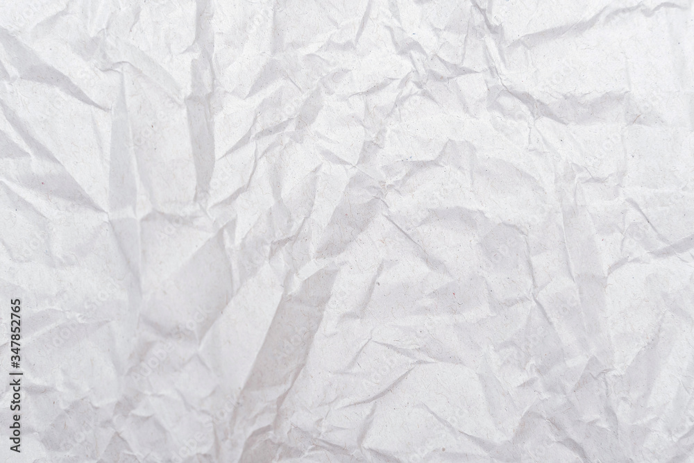 Naklejka premium White crumpled paper texture. Abstract paper pattern for background. Close-up.