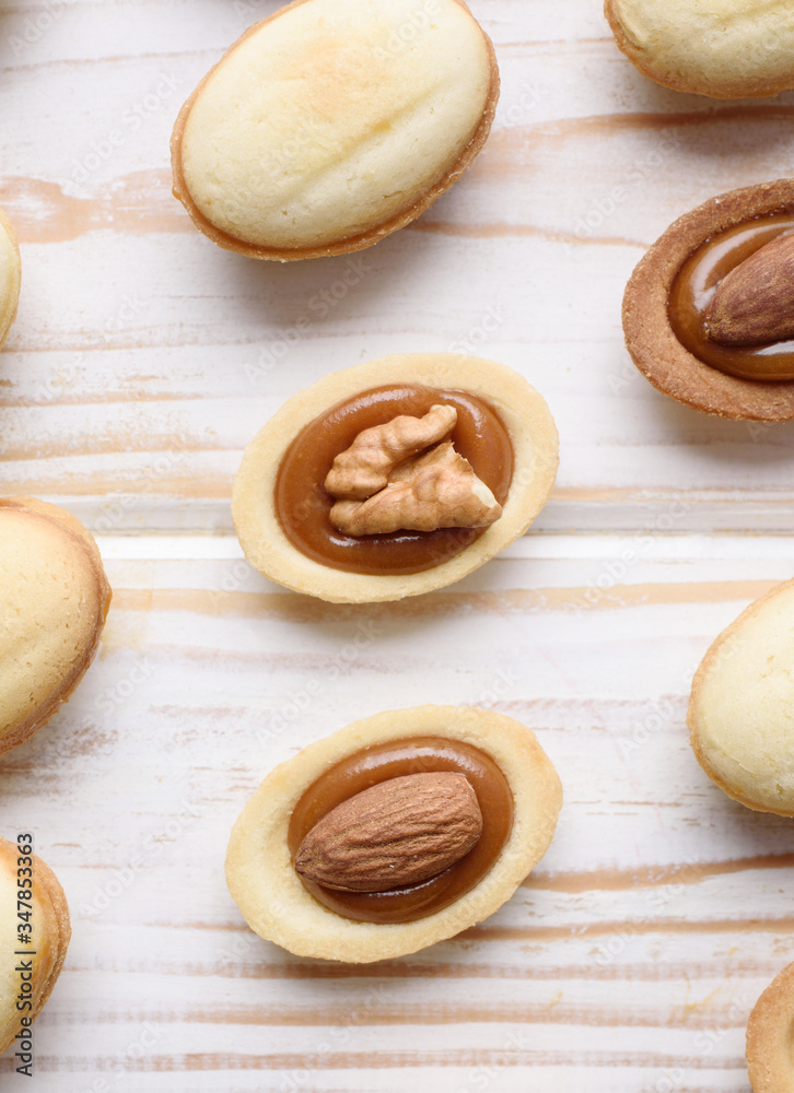 Homemade Russian nuts with condensed milk and mascarpone on a light blue background, wafer napkin. Cut nuts with condensed milk. Bitten goodies for tea. Condensed Nuts Homemade Russian nuts with condensed milk and mascarpone on a light blue background, wafer napkin. Cut nuts with condensed milk. Bitten goodies for tea. Condensed Nuts
