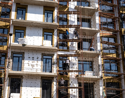Workers work on scaffolding