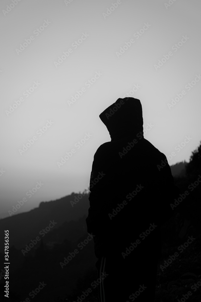 silhouette of man standing on rock