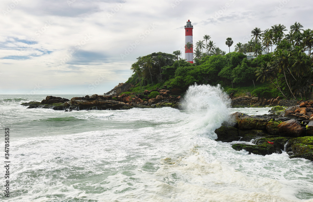Lighthouse on the rocks near the ocean in Kovalam, Kerala, India