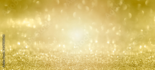 Abstract bokeh lights with soft light bokeh goldn colorful glows sparkle beautifuln christmas and new year holidays background with champagne.