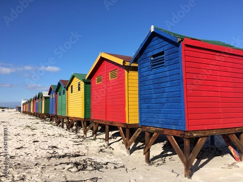 colorful beach huts at the beach © Michele