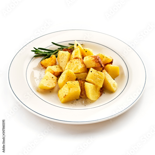 Fried baked potatoes with rosemary on a white plate.