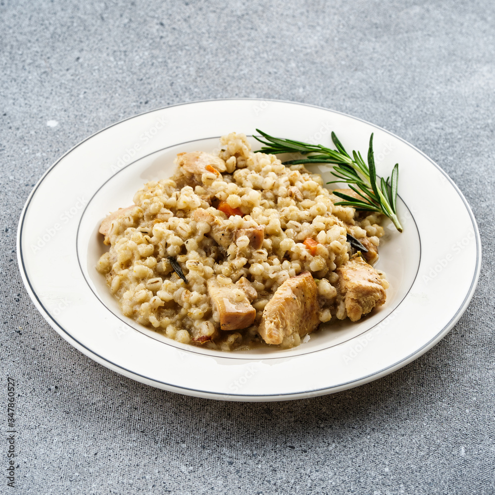 Barley porridge with meat on white plate. Barley porridge with meat on white plate.