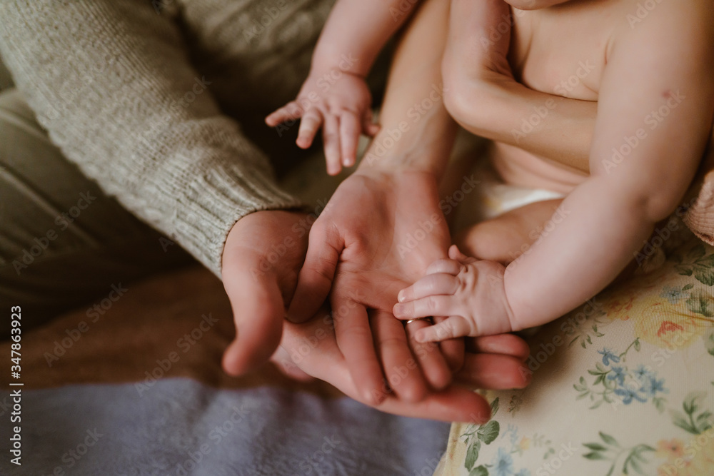 human hands of mom and baby dad human hands of mom and baby dad