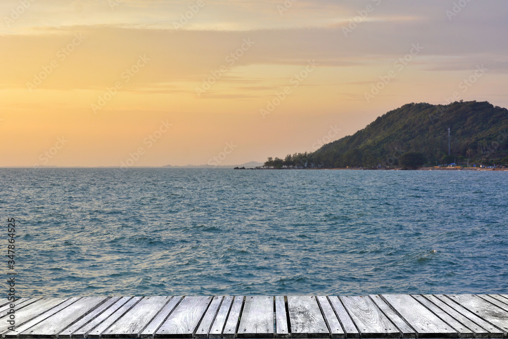 Sunset at sea and old wooden bridgeมPerspective view of wooden pier on the sea at sunset with perfectly specular reflection,wooden retro deck and sunrise or sunset sky/ Summer holidays background. Sunset at sea and old wooden bridgeมPerspective view of wooden pier on the sea at sunset with perfectly specular reflection,wooden retro deck and sunrise or sunset sky/ Summer holidays background.
